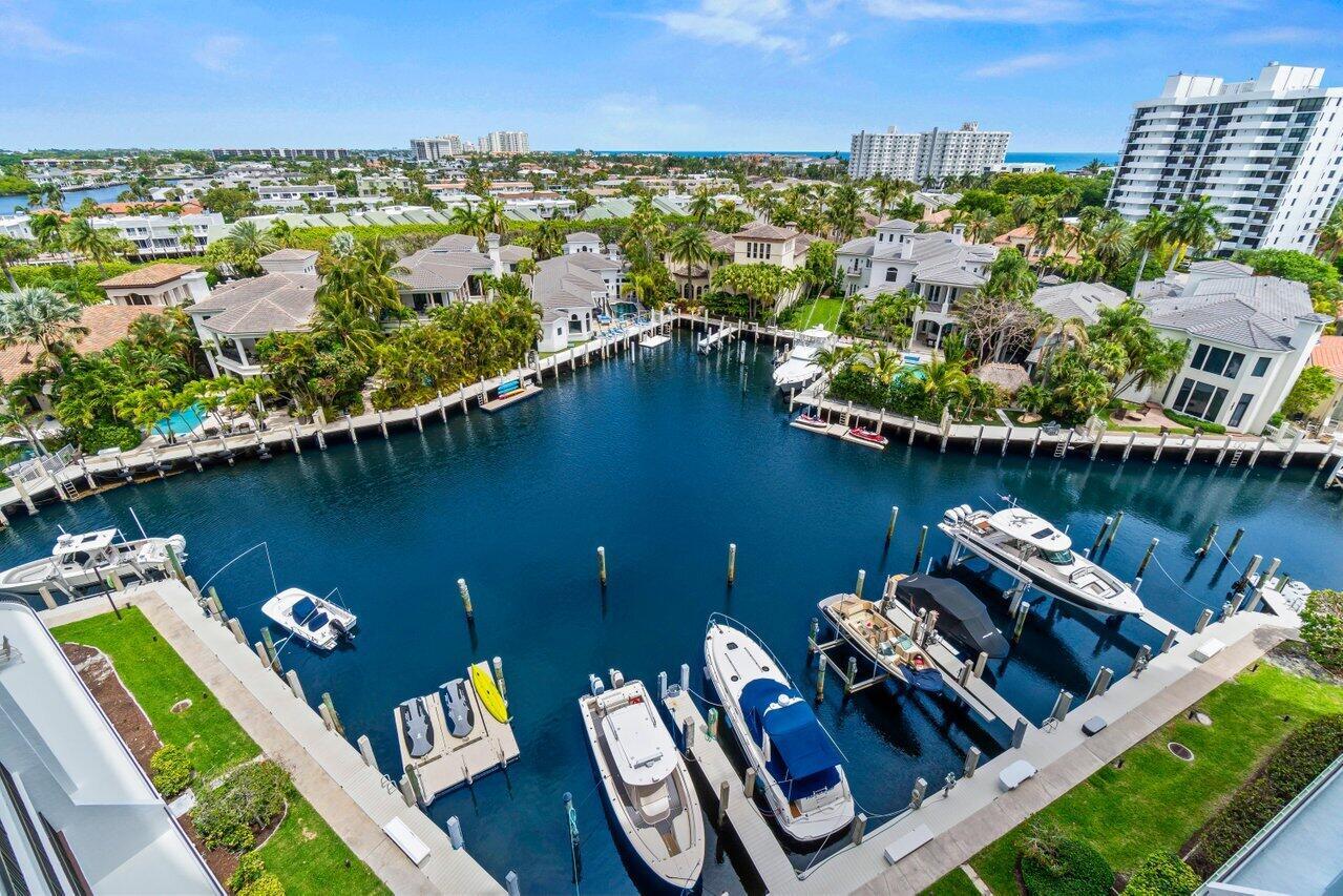 An aerial view of a canal lined with luxury homes and private boat docks — 4740 S Ocean Boulevard # 903, Highland Beach FL 33487, HIGHLAND BEACH, FL
