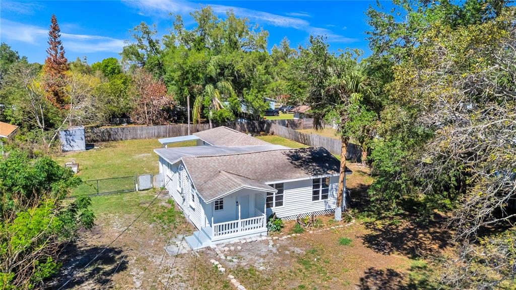An aerial view shows a white, single-story house with a shingled roof and fenced yard — 4311 TONY STREET, ORLANDO, FL