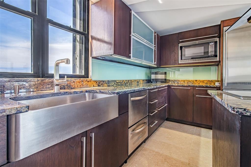 A modern kitchen features dark wood cabinets, stainless steel appliances, and a farmhouse sink — 1715 COND. LA INMACULADA PLAZA I UNIT PH4, SAN JUAN, PR