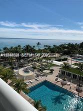 An elevated view of a swimming pool and patio area overlooking the ocean — 10275 Collins Ave # 1435, Bal Harbour FL 33154, BAL HARBOUR, FL