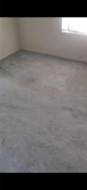 An empty room with gray carpet and a window on the right wall — 1124 ALABAMA STREET, TALLAHASSEE, FL