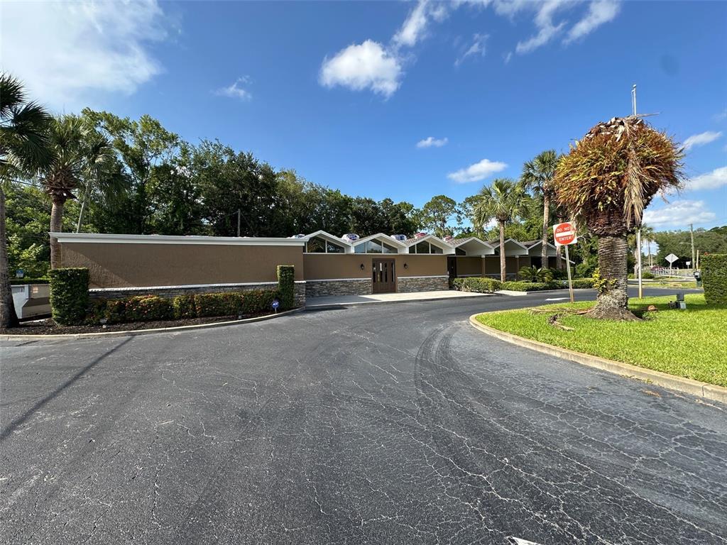 A low-slung commercial building with a brown facade and a series of triangular roof peaks — 500 E AIRPORT BOULEVARD, SANFORD, FL