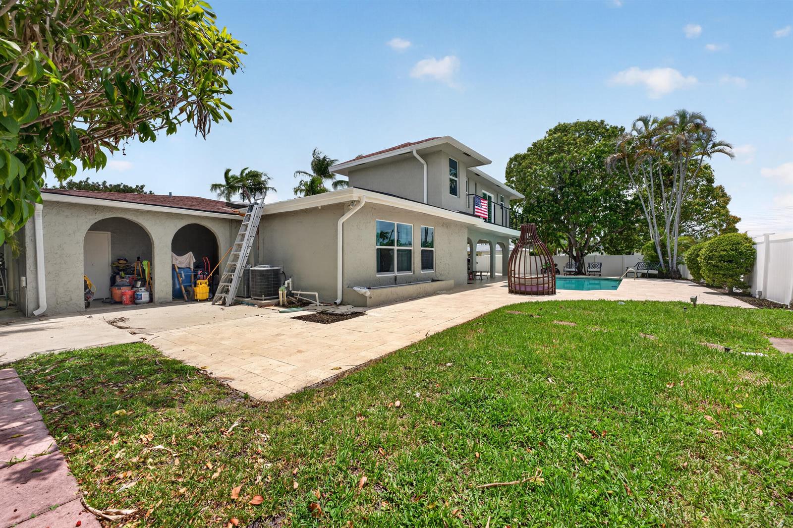 The exterior of a two-story house features a backyard with a pool and patio area — 10941 Granite Street, Boca Raton FL 33428, BOCA RATON, FL