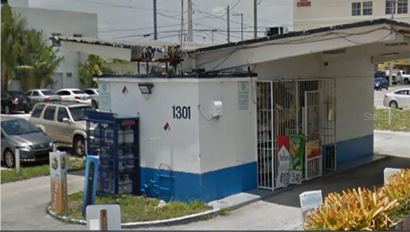 A small, white, single-story commercial building with a flat roof and blue trim — 1301 E COMMERCIAL BOULEVARD, OAKLAND PARK, FL