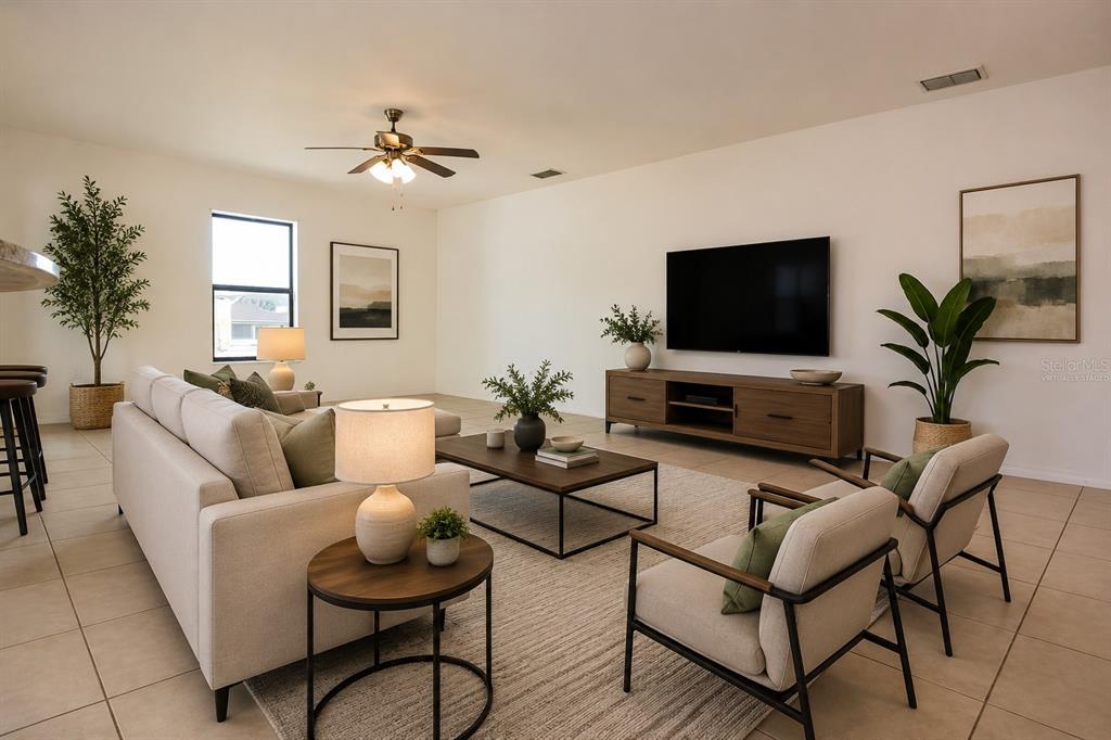 A living room features a beige sofa, two armchairs, a coffee table, and a television — 6936 CRESTED ORCHID DRIVE, BROOKSVILLE, FL