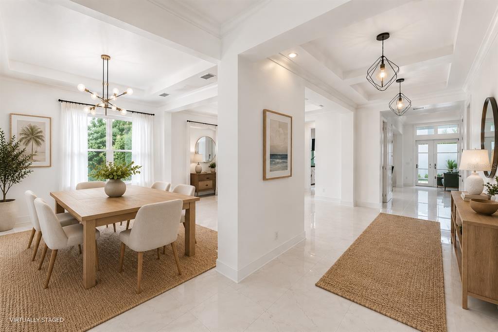 A bright dining room and entryway feature white walls, tile floors, and modern light fixtures — 12664 BANTING TERRACE, ORLANDO, FL