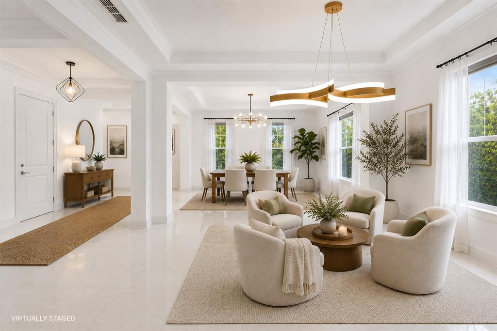 An open-concept living and dining area features white walls, tile floors, and modern light fixtures — 12664 BANTING TERRACE, ORLANDO, FL