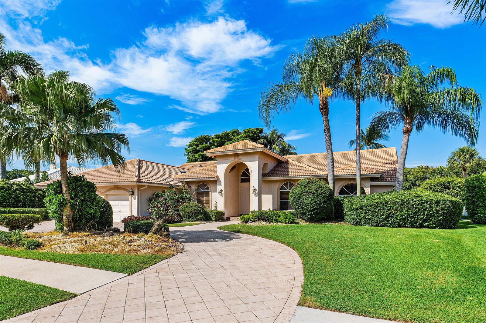 A single-story house with a tiled roof, arched entryway, and palm trees in the front yard — 17571 Bocaire Way, Boca Raton FL 33487, BOCA RATON, FL