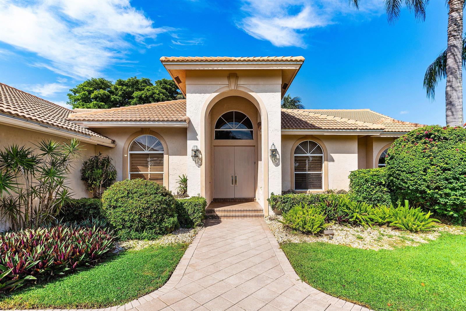 A single-story house with a tiled roof, arched entryway, and a paved walkway — 17571 Bocaire Way, Boca Raton FL 33487, BOCA RATON, FL