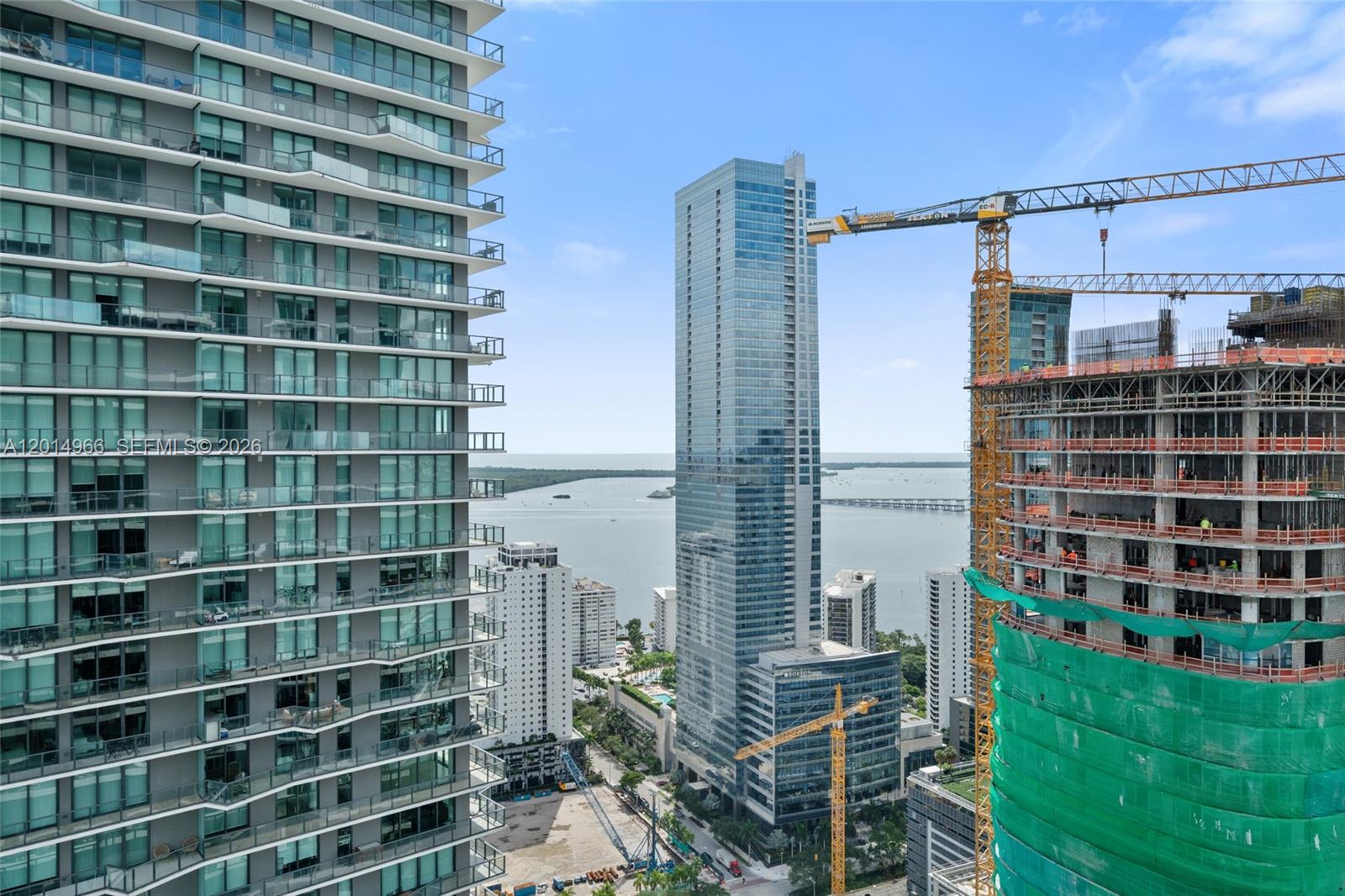 An exterior view shows a high-rise building next to a construction site with a crane — 60 SW 13th St # 4008, Miami FL 33130, MIAMI, FL