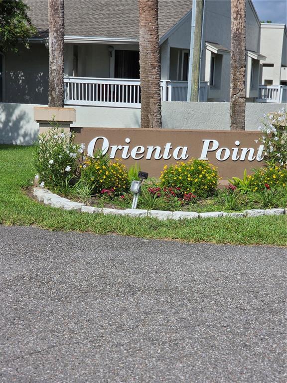 A brown sign reading Orienta Point sits in front of a building with palm trees — 266 ORIENTA POINT STREET, ALTAMONTE SPRINGS, FL