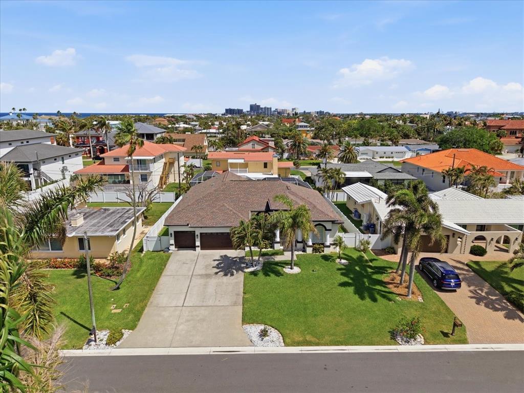 An aerial view of a suburban house with a brown roof and a concrete driveway — 109 16TH STREET, BELLEAIR BEACH, FL