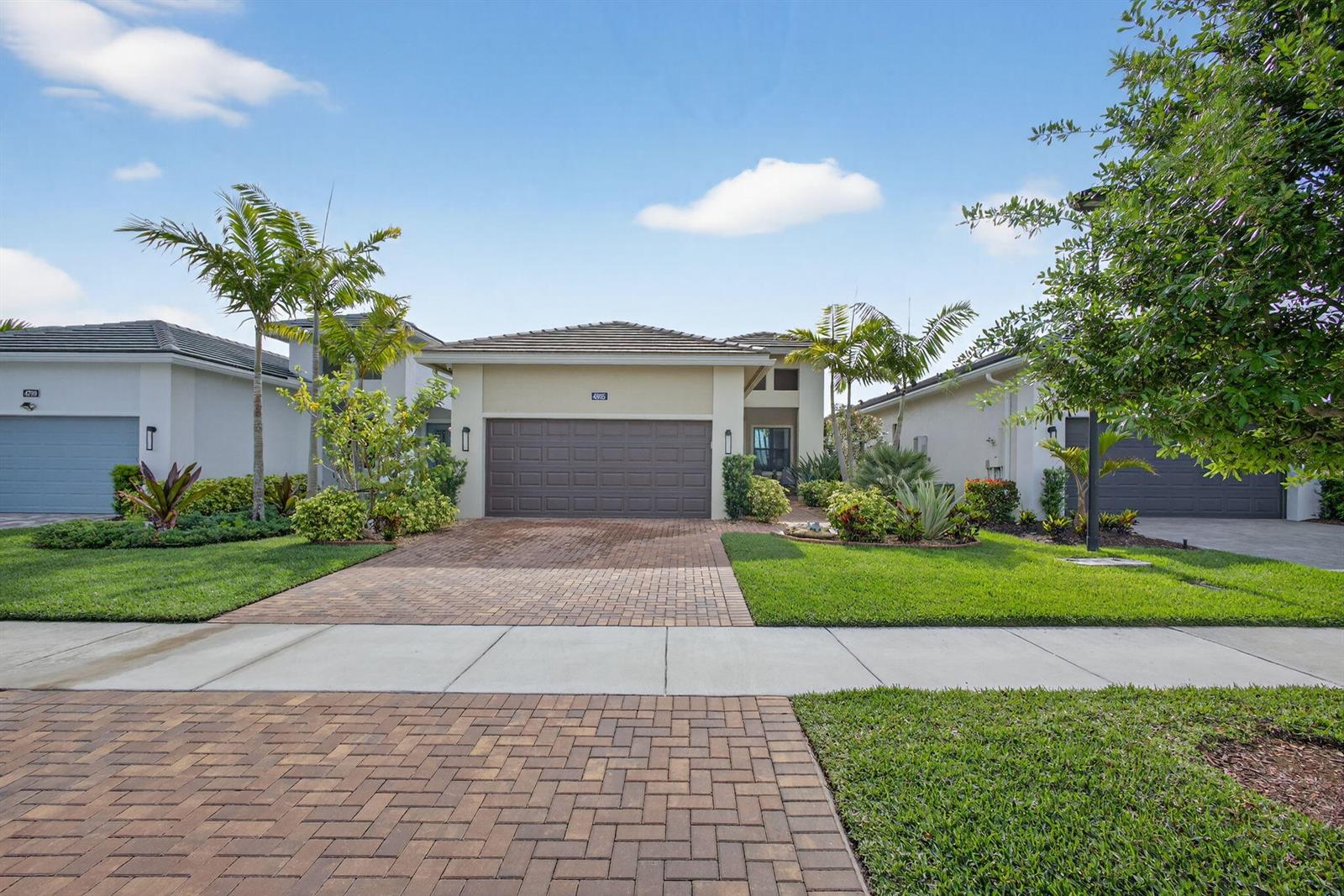 A single-story house with a brown garage door and a brick paver driveway — 4805 Saint Armands Way, Westlake FL 33470, WESTLAKE, FL