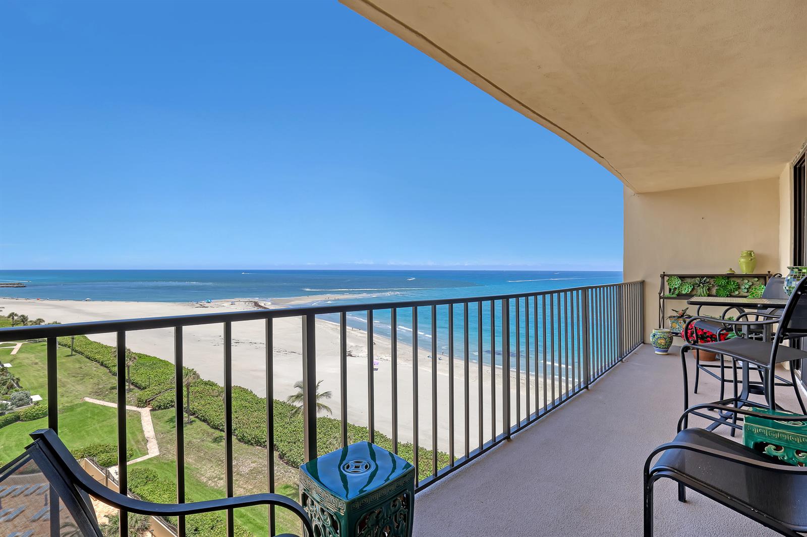A balcony with metal railings overlooks a sandy beach and the ocean — 100 Ocean Trail Way # 1002, Jupiter FL 33477, JUPITER, FL
