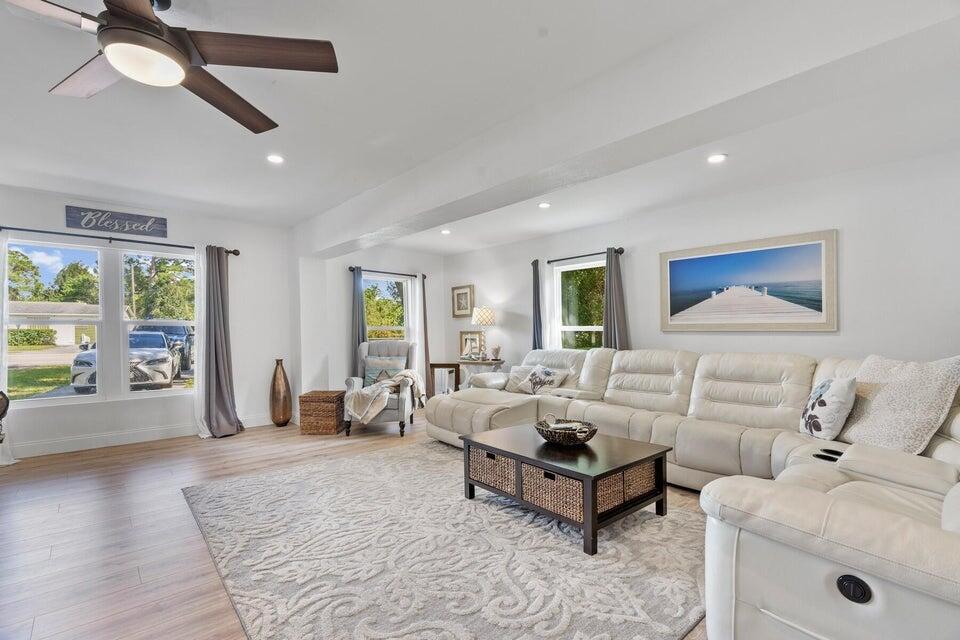 A living room features a white sectional sofa, a coffee table, and light wood flooring — 301 20th Avenue SW, Vero Beach FL 32962, VERO BEACH, FL