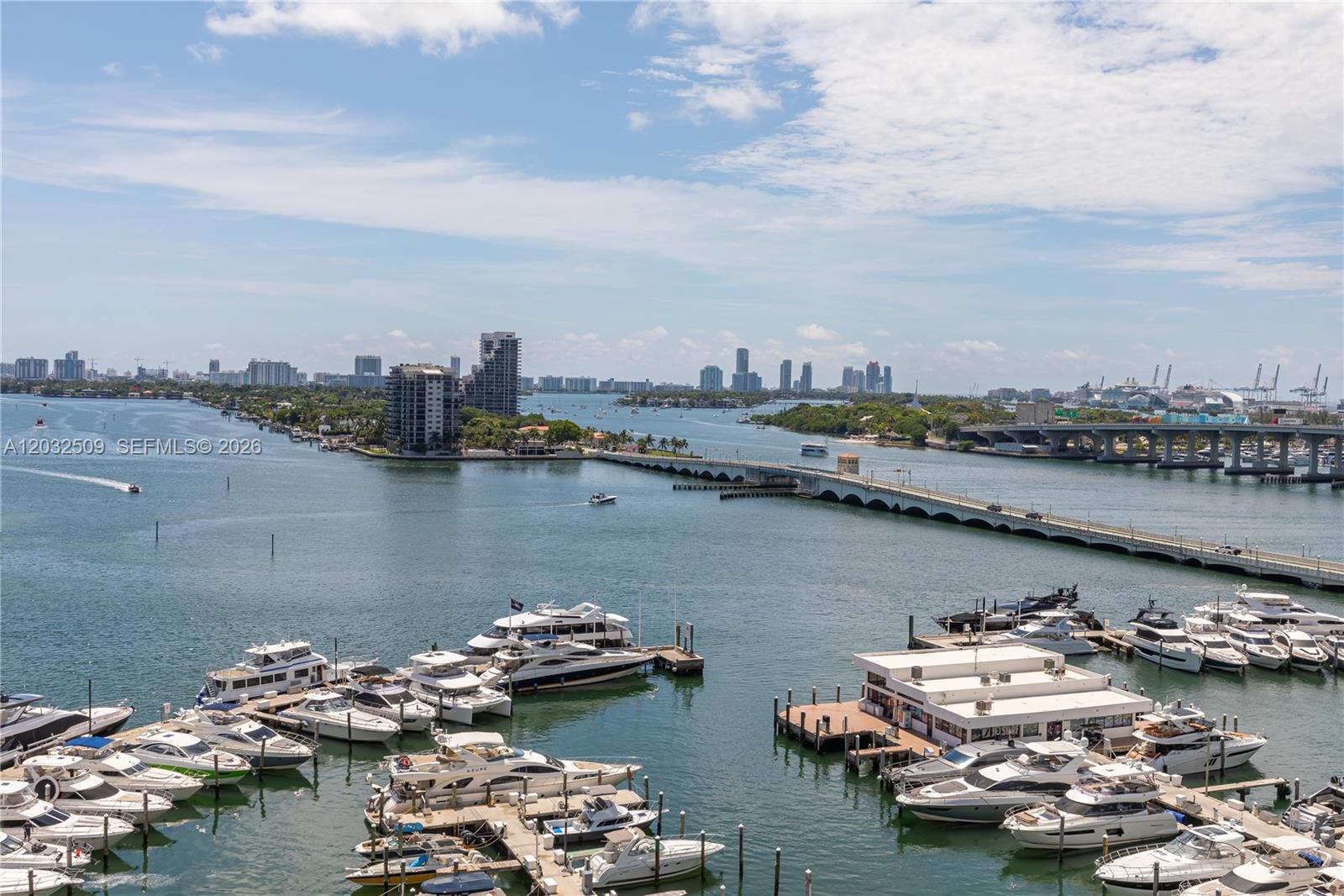 An aerial view shows a marina with numerous yachts and a bridge spanning the water — 1717 N Bayshore Dr # 1533, Miami FL 33132, MIAMI, FL