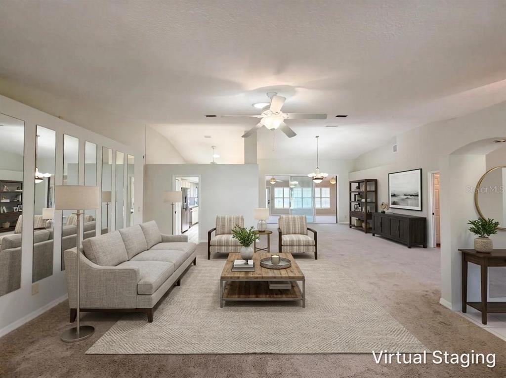 A living room features a sofa, two armchairs, a coffee table, and a mirrored wall — 27305 RACQUET CIRCLE, LEESBURG, FL