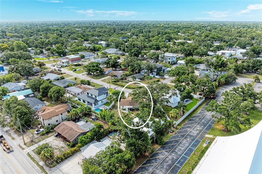 An aerial view shows a single-story house circled in a residential neighborhood near a parking lot — 1300 LOMA LINDA COURT, SARASOTA, FL