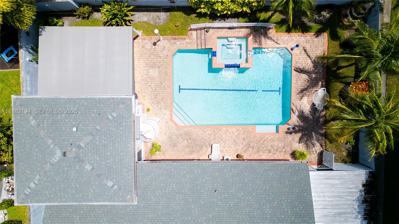 An aerial view shows a house with a shingled roof, a swimming pool, and landscaping — 11680 SW 92nd St, Miami FL 33176, MIAMI, FL