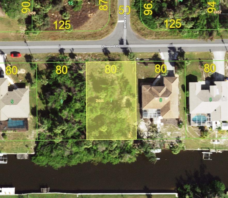 This is an aerial map showing a vacant residential lot situated along a canal — 690 LOMOND DRIVE, PORT CHARLOTTE, FL