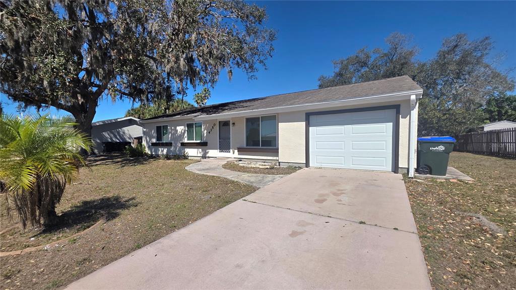 A single-story house with a white garage door, light-colored siding, and a concrete driveway — 4350 MARALDO AVENUE, NORTH PORT, FL