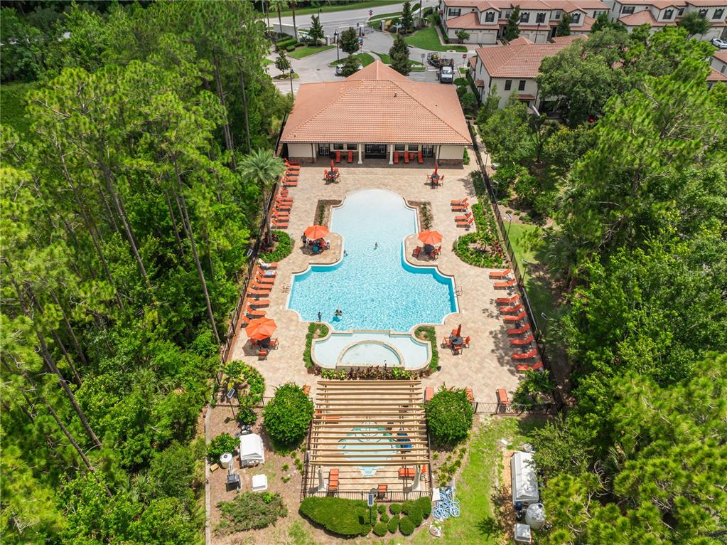 An aerial view shows a community swimming pool with lounge chairs and a covered pergola — 8221 ROSEVILLE ROAD, DAVENPORT, FL