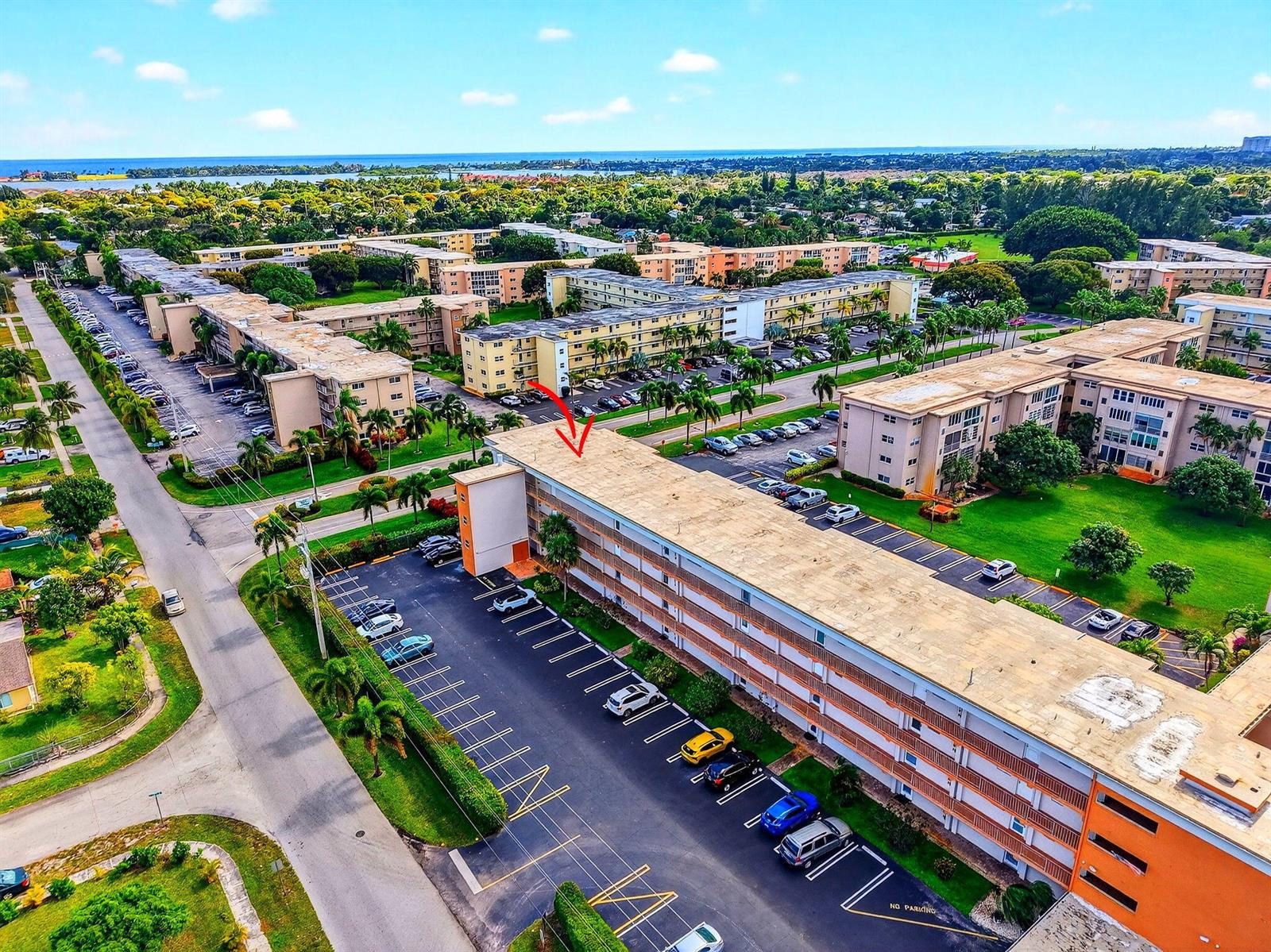 An aerial view shows a multi-story apartment complex with surrounding parking lots and green spaces — 230 NE 26th Avenue # 302, Boynton Beach FL 33435, BOYNTON BEACH, FL