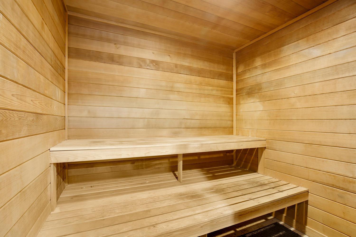 A sauna room featuring light-colored wood paneling and two tiered wooden benches — 255 NE 3rd Avenue Unit 407, Delray Beach FL 33444, DELRAY BEACH, FL