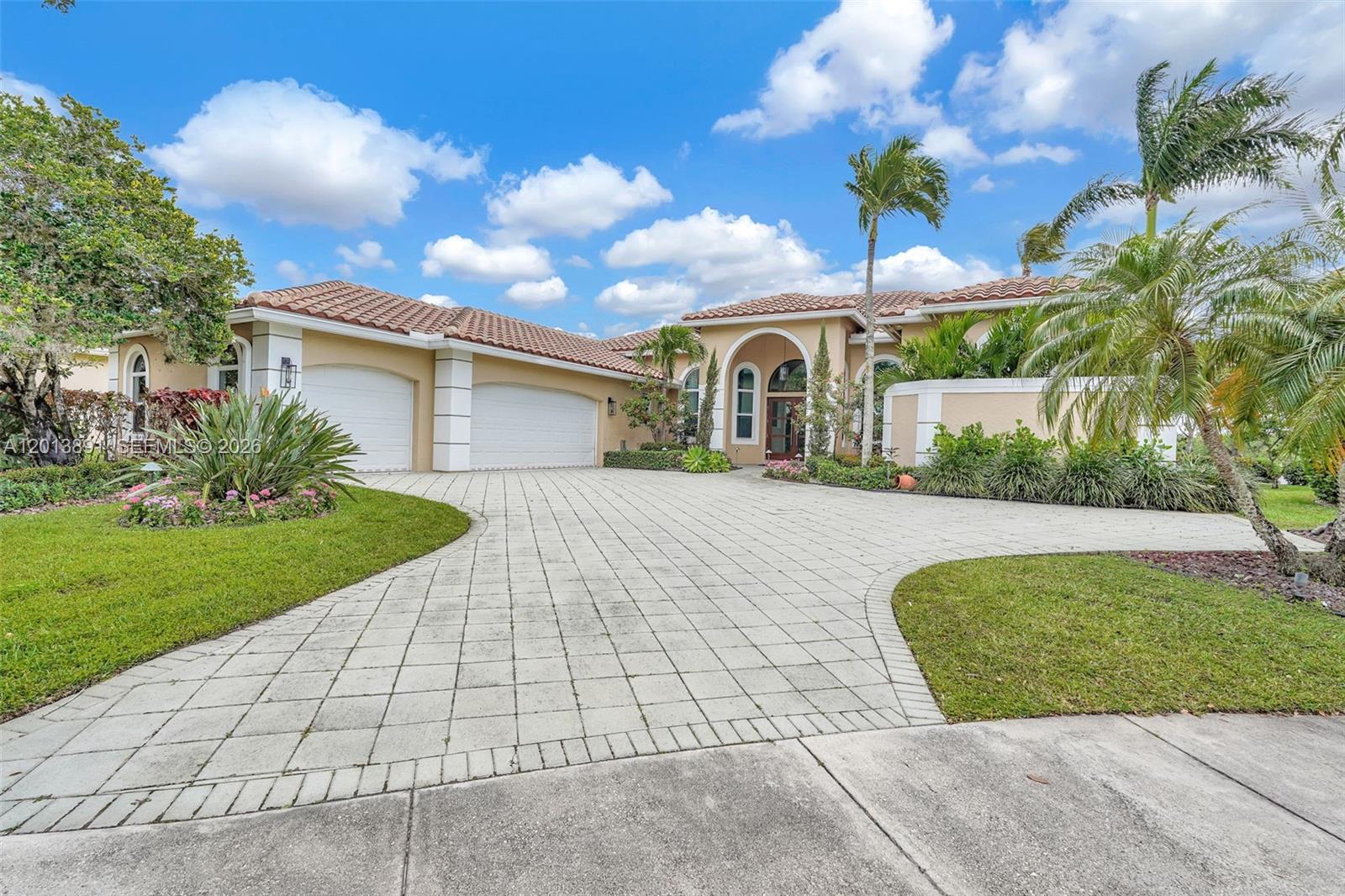 A single-story house with a tiled roof, two-car garage, and a paved driveway — 2715 Edgewater Court, Weston FL 33332, WESTON, FL