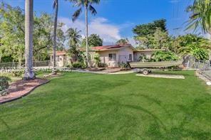 A single-story house with a large green lawn and a boat on a trailer — 2199 NE 182nd St # 2, North Miami Beach FL 33162, NORTH MIAMI BEACH, FL