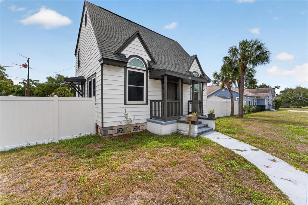 A white two-story house with a dark roof and a small covered front porch — 1900 16TH STREET S, ST PETERSBURG, FL