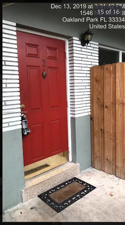 A red front door with a keypad lock and a number two sign — OAKLAND PARK, FL