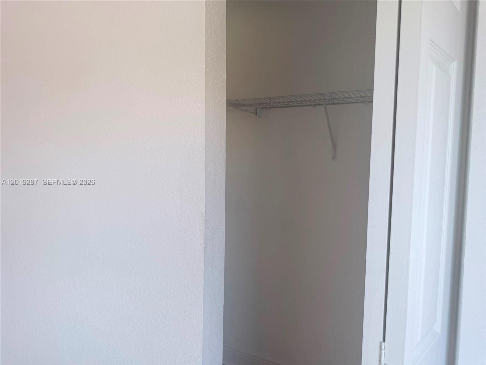A kitchen features light wood cabinets, stainless steel appliances, and a white refrigerator — 7989 NW 8th St # 107D, Miami FL 33126, MIAMI, FL