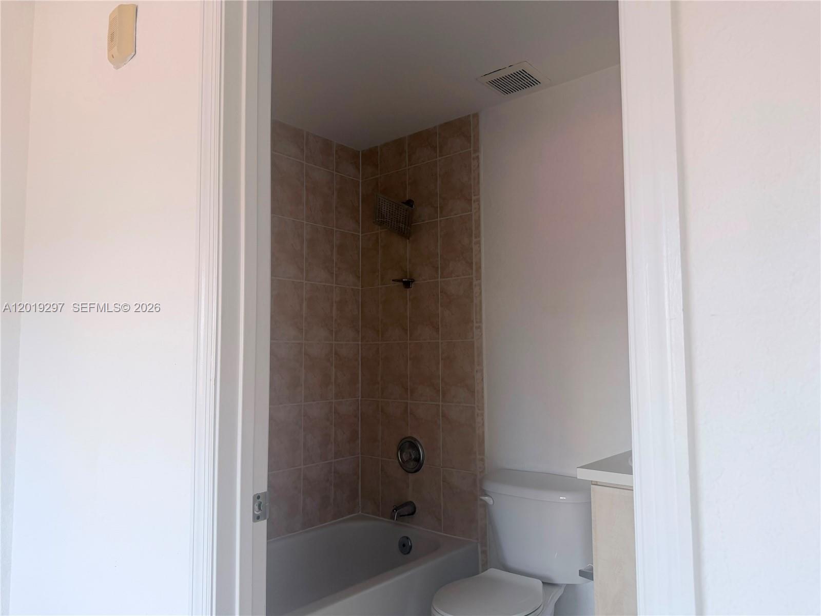 A kitchen features light wood cabinets, stainless steel appliances, and a white refrigerator — 7989 NW 8th St # 107D, Miami FL 33126, MIAMI, FL