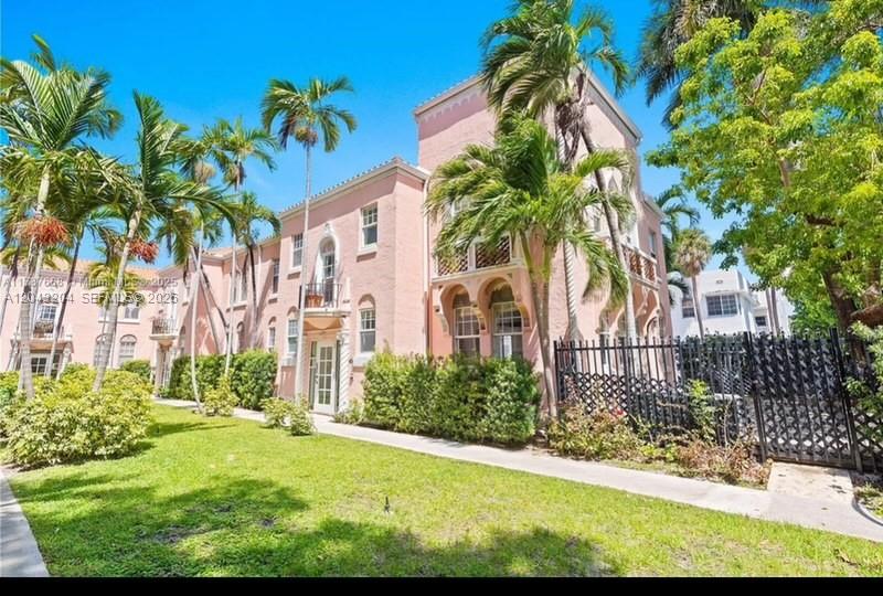 A multi-story pink stucco apartment building features arched windows and palm trees on a lawn — 760 Meridian Ave # 3, Miami Beach FL 33139, MIAMI BEACH, FL