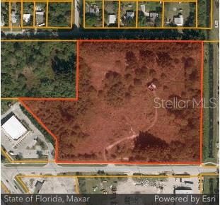 This aerial map shows a large, undeveloped parcel of land outlined in red — 3214 AVENUE D, FORT PIERCE, FL