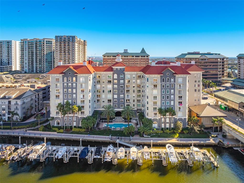 An aerial view shows a multi-story waterfront apartment building with a pool and boat slips — 700 S HARBOUR ISLAND BOULEVARD UNIT 647, TAMPA, FL