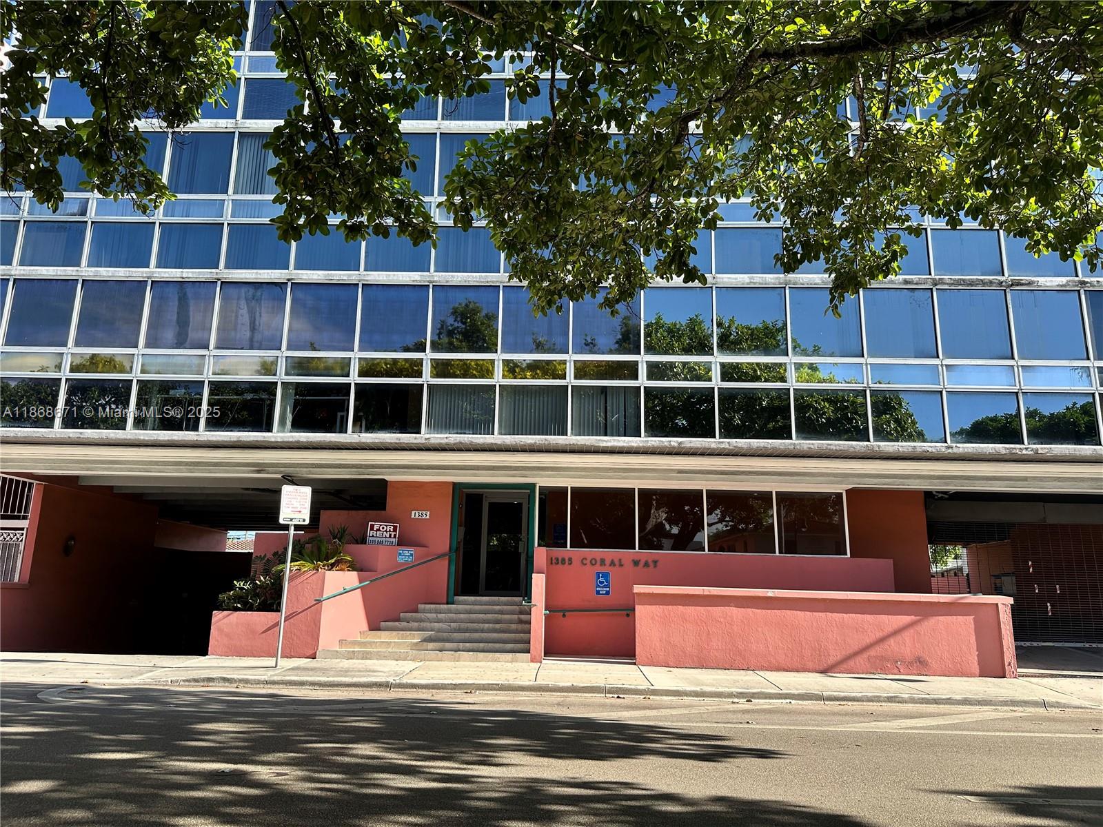 A multi-story office building with a glass facade and a pink ground-level entrance — 1385 SW 22nd St # 201, Miami FL 33145, MIAMI, FL