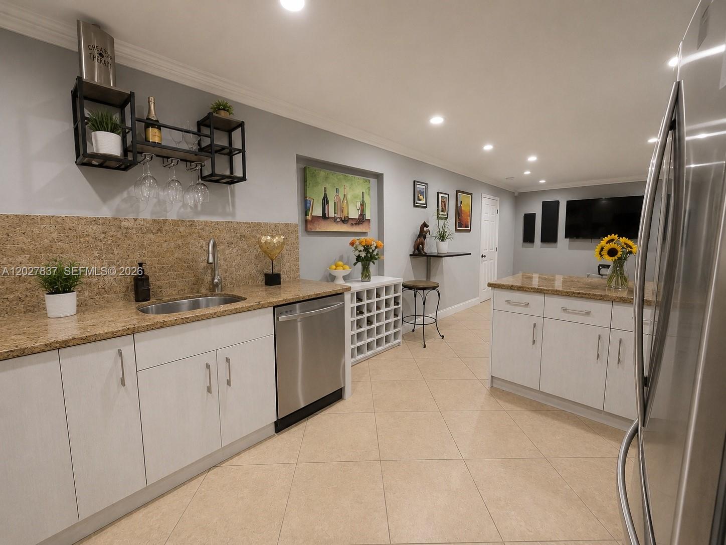 A kitchen features white cabinets, granite countertops, a stainless steel dishwasher, and a wine rack — 7513 Grant Ct # A, Hollywood FL 33024, HOLLYWOOD, FL