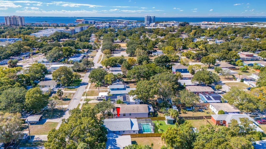 An aerial view of a residential neighborhood featuring a house with a backyard swimming pool — 4409 W PEARL AVENUE, TAMPA, FL