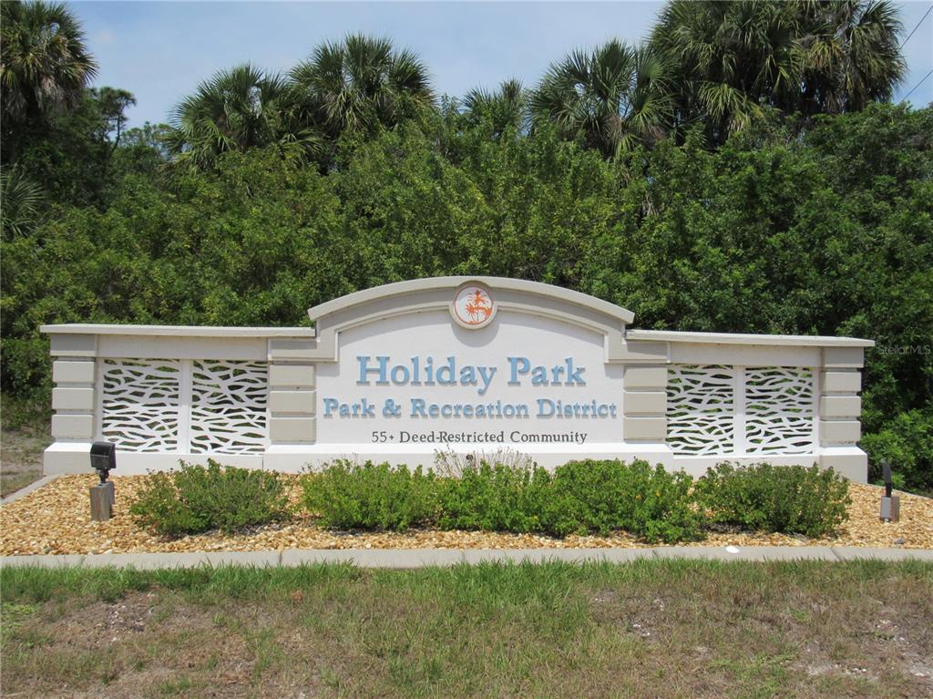 A sign for Holiday Park Park & Recreation District stands in front of lush green trees — 5709 HOLIDAY PARK BOULEVARD, NORTH PORT, FL