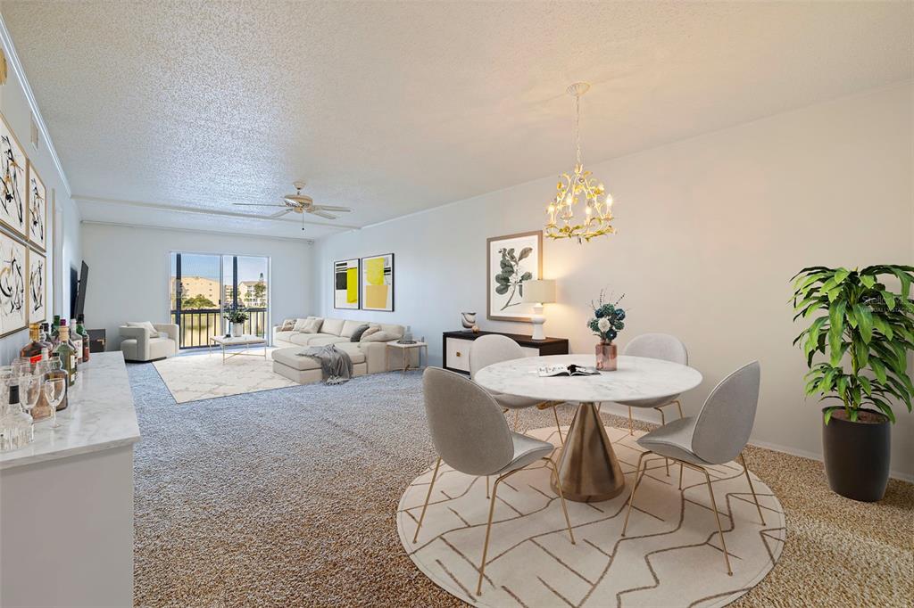 A dining area with a round table and a living room with a balcony view — 3408 LAKE BAYSHORE DRIVE UNIT P-317, BRADENTON, FL