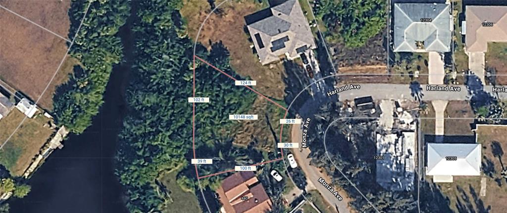 An aerial view shows a vacant, irregularly shaped residential lot outlined in red — MONZA AVENUE, NORTH PORT, FL