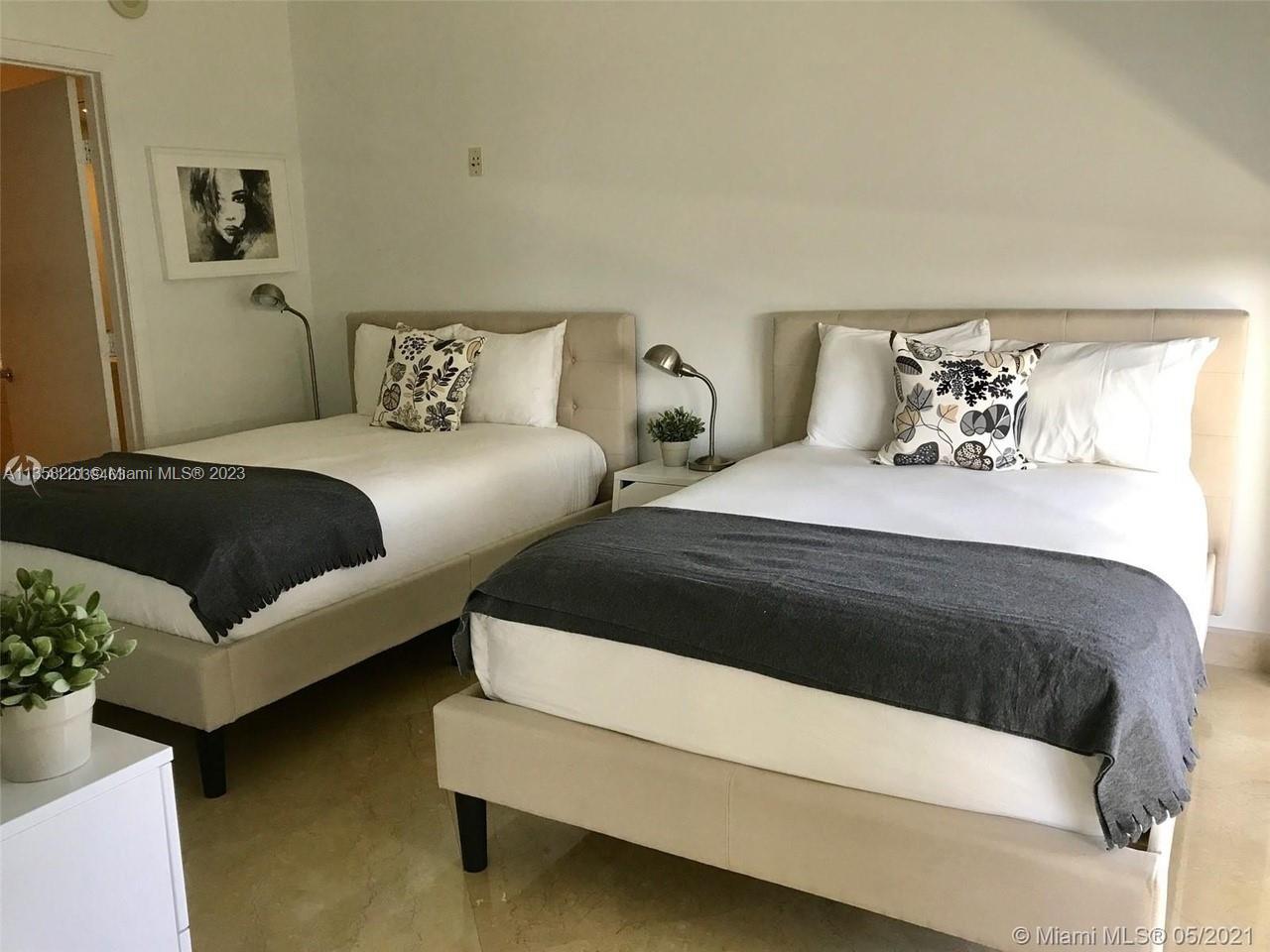 A bedroom features two beige upholstered beds with white bedding and dark gray throws — 1830 S Ocean Dr # 1706, Hallandale Beach FL 33009, HALLANDALE BEACH, FL