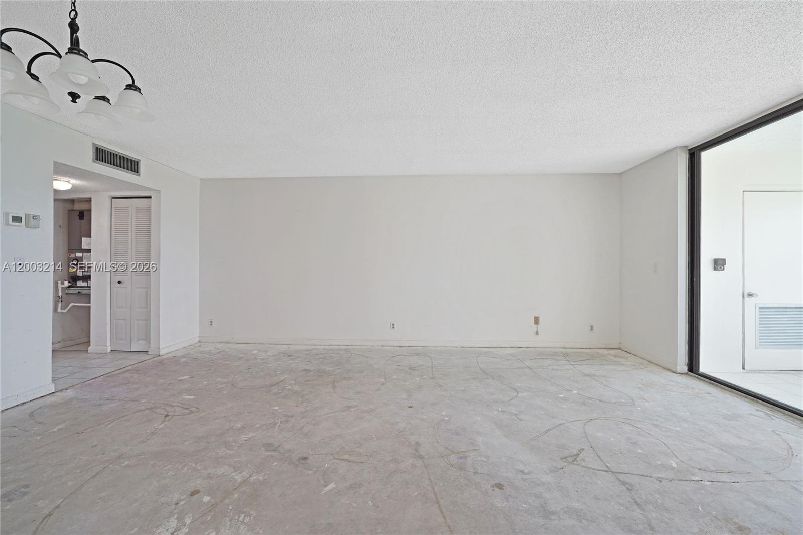 An empty room with white walls, a popcorn ceiling, and an unfinished concrete floor — 7330 NW 18th St # 204, Margate FL 33063, MARGATE, FL