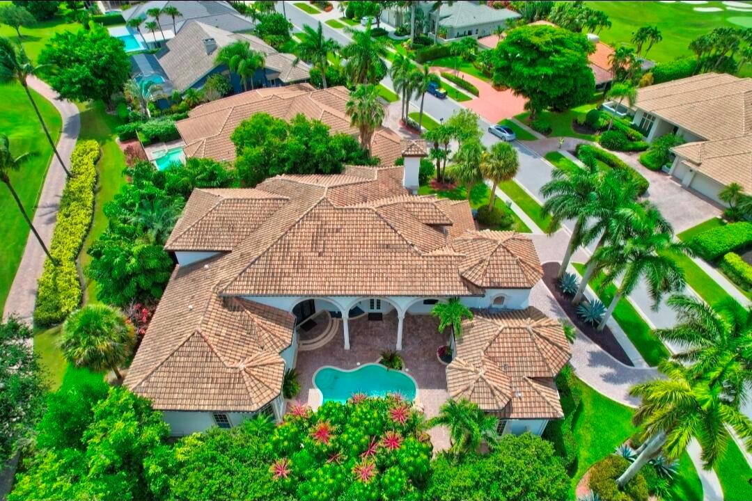 An aerial view of a house with a tiled roof, swimming pool, and surrounding palm trees — 7635 Mandarin Drive, Boca Raton FL 33433, BOCA RATON, FL