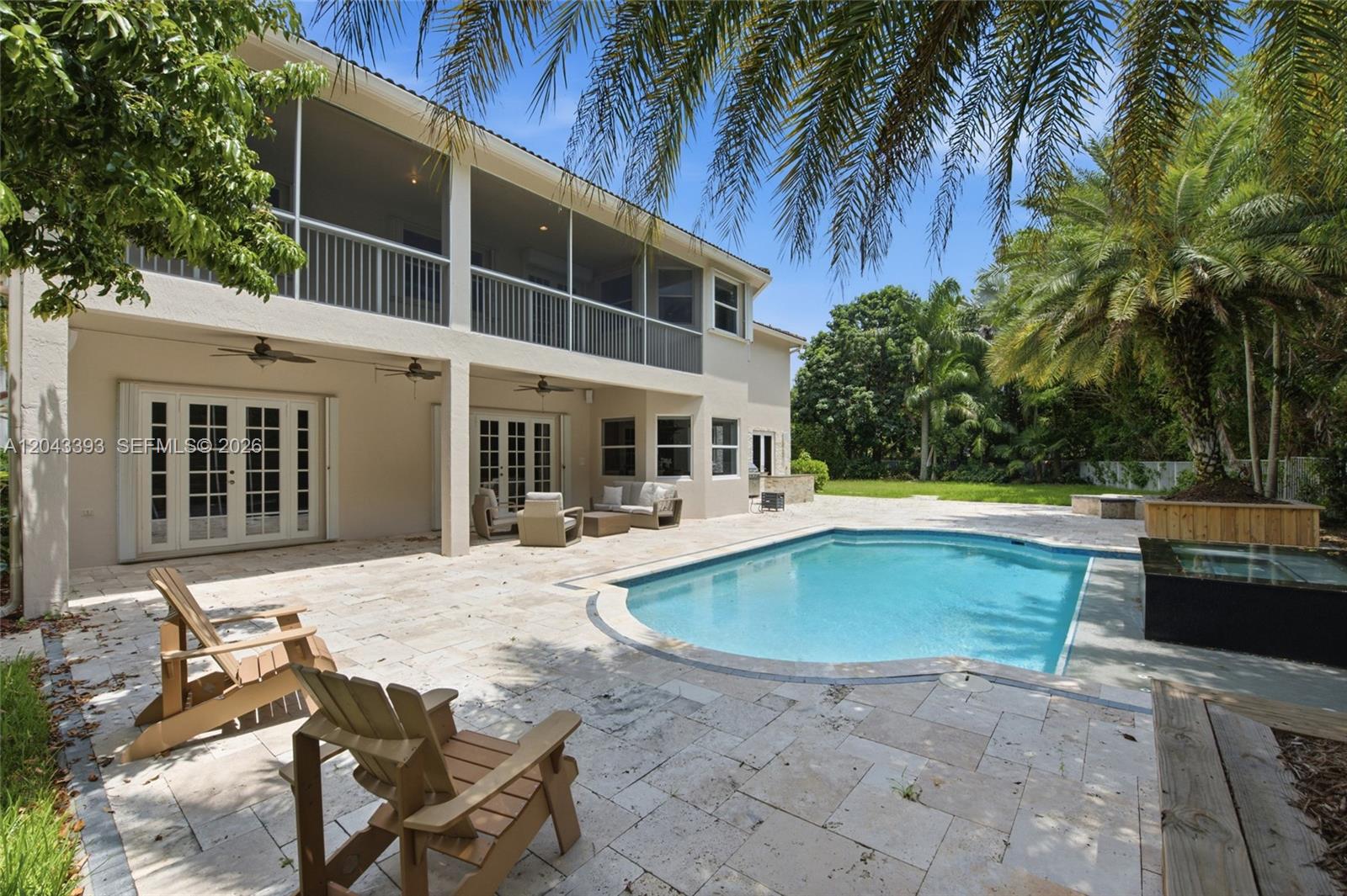 A two-story house with a screened balcony overlooks a backyard patio and swimming pool — 1585 Victoria Isle Way, Weston FL 33327, WESTON, FL