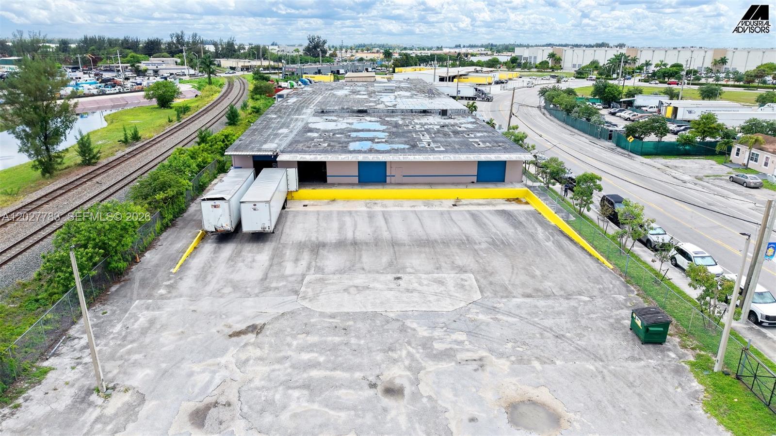 An aerial view shows a warehouse with a loading dock, two trailers, and a parking lot — 160 Ali Baba Ave, Opa-Locka FL 33054, OPA-LOCKA, FL