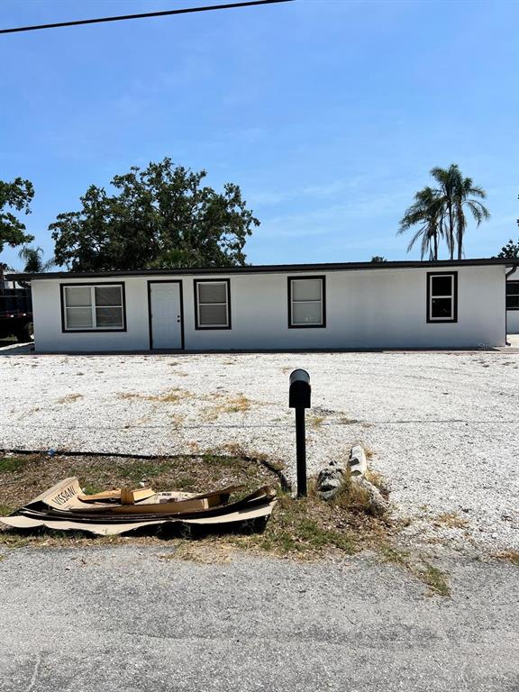 A white, single-story manufactured home sits on a gravel lot with a black mailbox — 901 PADUA COURT, NOKOMIS, FL
