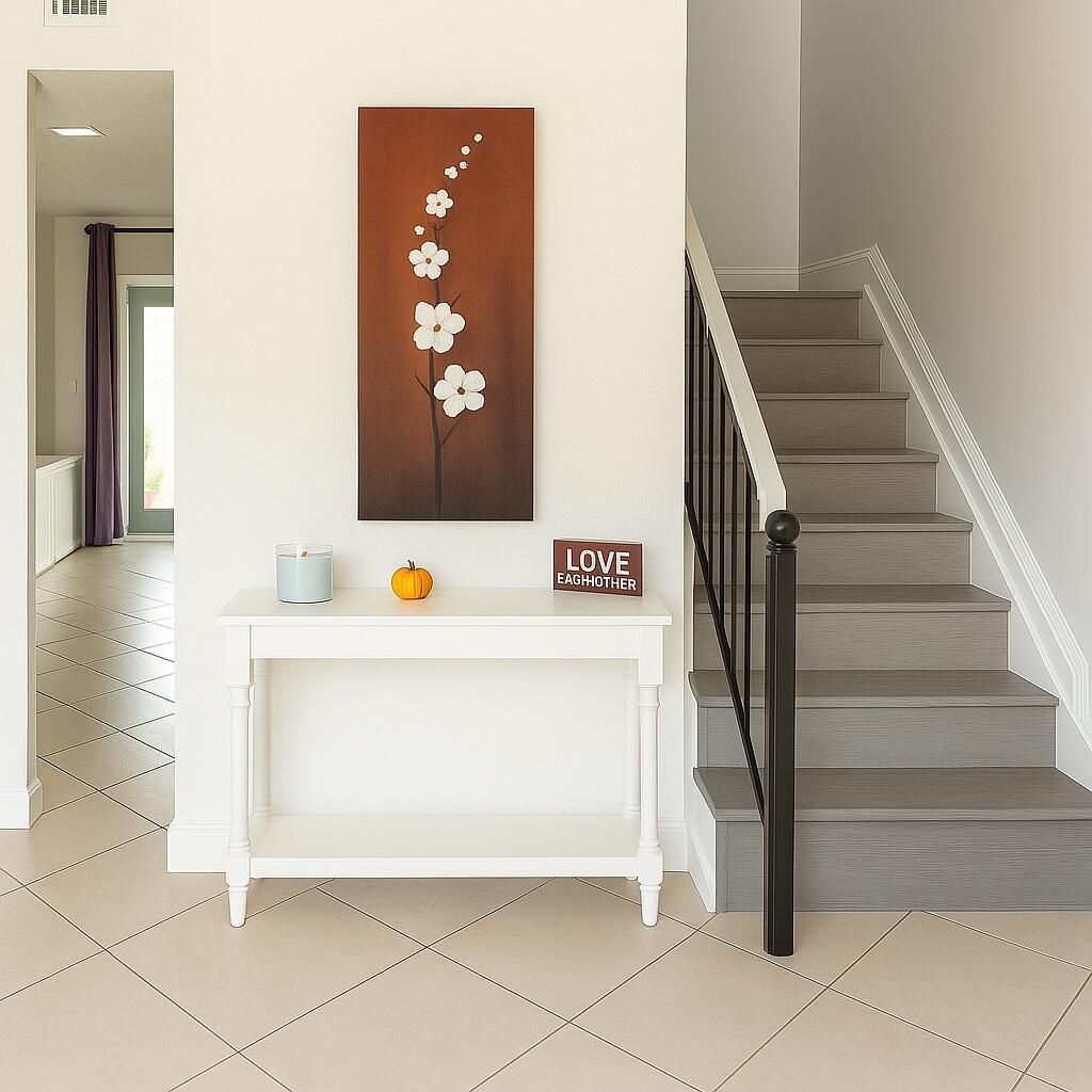 A white console table sits in a foyer with a staircase and wall art — 6639 SW 41st Place # 41, Davie FL 33314, DAVIE, FL